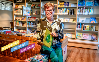 Ingrid Buijs zit op de bank in de bibliotheek met boeken om haar heen en ze heeft er een vast