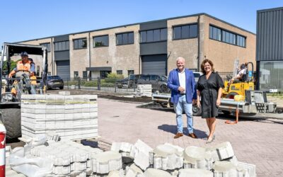 Wethouder Eric Faassen en ondernemer Monique Maurik staan achter een stapel stenen in Capelle-West.